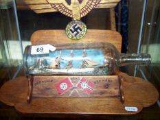 Sailing ship in bottle on a stand featuring Nazi symbols