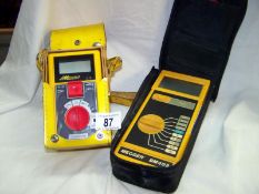 2 insulation and continuity testers with cases and cables