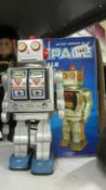 A boxed 1970's tinplate battery space walk man robot