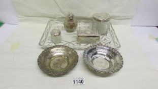 A glass tray with 4 silver topped dressing table bottles and 2 silver dishes (1 a/f)