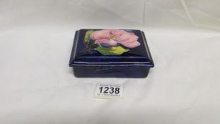 A Moorcroft magnolia trinket box and lid,