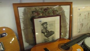 A framed and glazed Player's aadvert and an old piece of tapestry with the name Chippendale