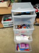 A 4 drawer storage unit with art and craft items including glitter glue etc