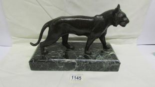 A bronze tiger on marble base