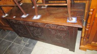 A period oak coffer with carved 3 panel front