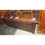 A period oak coffer with carved 3 panel front