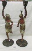 A pair of painted spelter arabesque figures