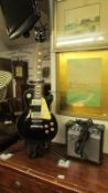 Les Paul style electric guitar with practice amplifier