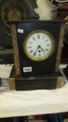 A black marble mantel clock, case loose,