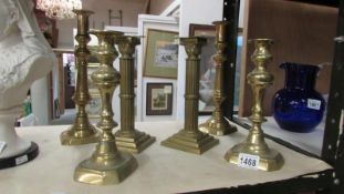 2 pairs of brass candlesticks and a pair of brass Corinthian column candlesticks