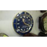A Rolex Submariner style dealer wall clock with battery movement