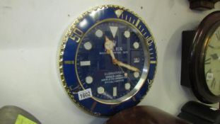 A Rolex Submariner style dealer wall clock with battery movement