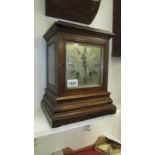A bracket clock with bevelled glass sides,