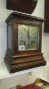 A bracket clock with bevelled glass sides,