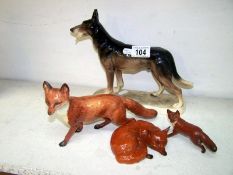 Dog figure and 3 Beswick foxes