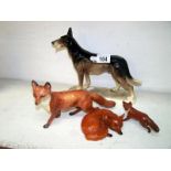 Dog figure and 3 Beswick foxes