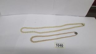 2 strings of pearls including one with 9ct gold clasp and safety chain and one with silver clasp