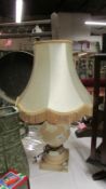 A large heavy carved pink alabaster table lamp