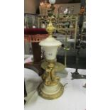 A white marble table lamp base with gilt metal plinth and mythical fish column