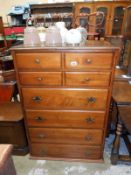 A dark wood stained chest of drawers