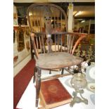 An early 19th century elm Windsor chair