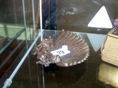 A small bronze visiting card stand of a lady holding a feather fan