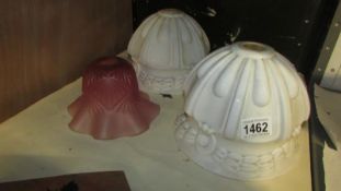 A pair of 1930's white glass lampshades and a cranberry glass lampshade