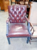 A deep buttoned leather Edwardian arm chair