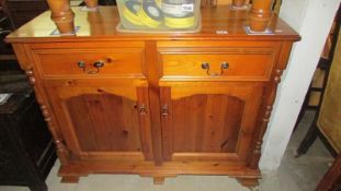 A solid pine 2 drawer 2 door cupboard