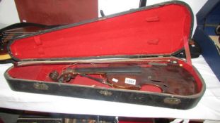 An old cased violin and bow,
