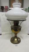 A brass oil lamp complete with opaque mushroom shade and chimney