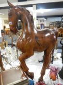 A large solid polished teak model of a horse