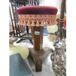 A Victorian mahogany piano stool with red velvet seat