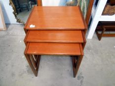 A vintage teak nest of 3 tables