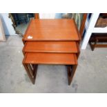 A vintage teak nest of 3 tables