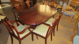 An oval mahogany dining table and 6 chairs