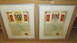 A pair of framed and glazed family crests