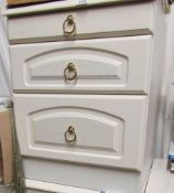 A white 3 drawer bedside chest