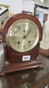 A mahogany inlaid mantel clock