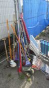 A quantity of garden tools, brooms etc