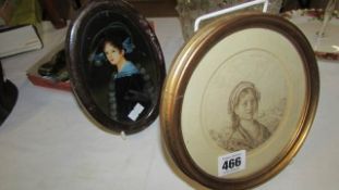 2 small oval framed portraits