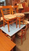 A formica top table and 4 chairs