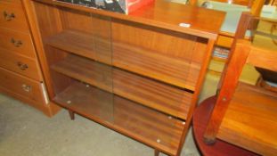 A teak sliding door cabinet