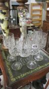 A cut glass decanter and 5 glasses