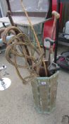 A stick stand and contents including walking sticks