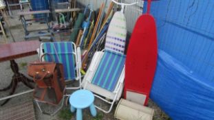 An ironing board, folding chairs etc