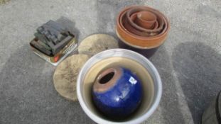 A quantity of garden pots, slabs etc