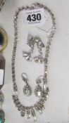 A diamonte necklace and 2 pairs of earrings