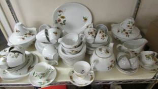 A shelf of dinner ware including Meakin