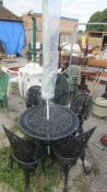 A metal garden table and 4 chairs